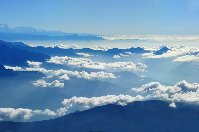 a view of mountains and clouds from an airplane, by Peter Churcher, pexels contest winner, sumatraism, light blue sky, sichuan, panorama view of the sky, slide show