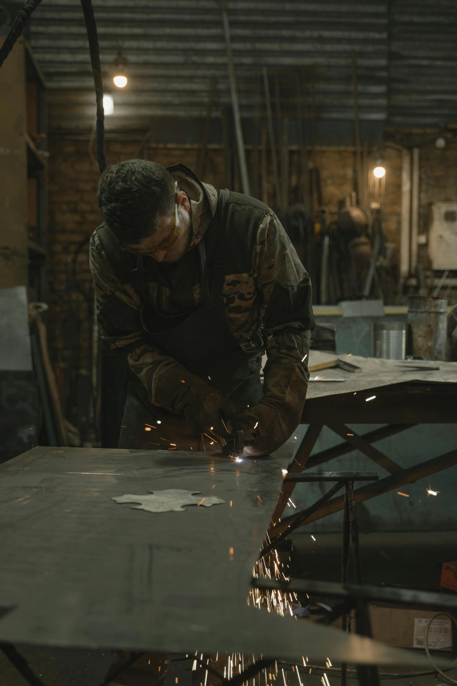 a man working on a piece of metal, trending on imdb, full body hero, still frame from a movie, very cinematic