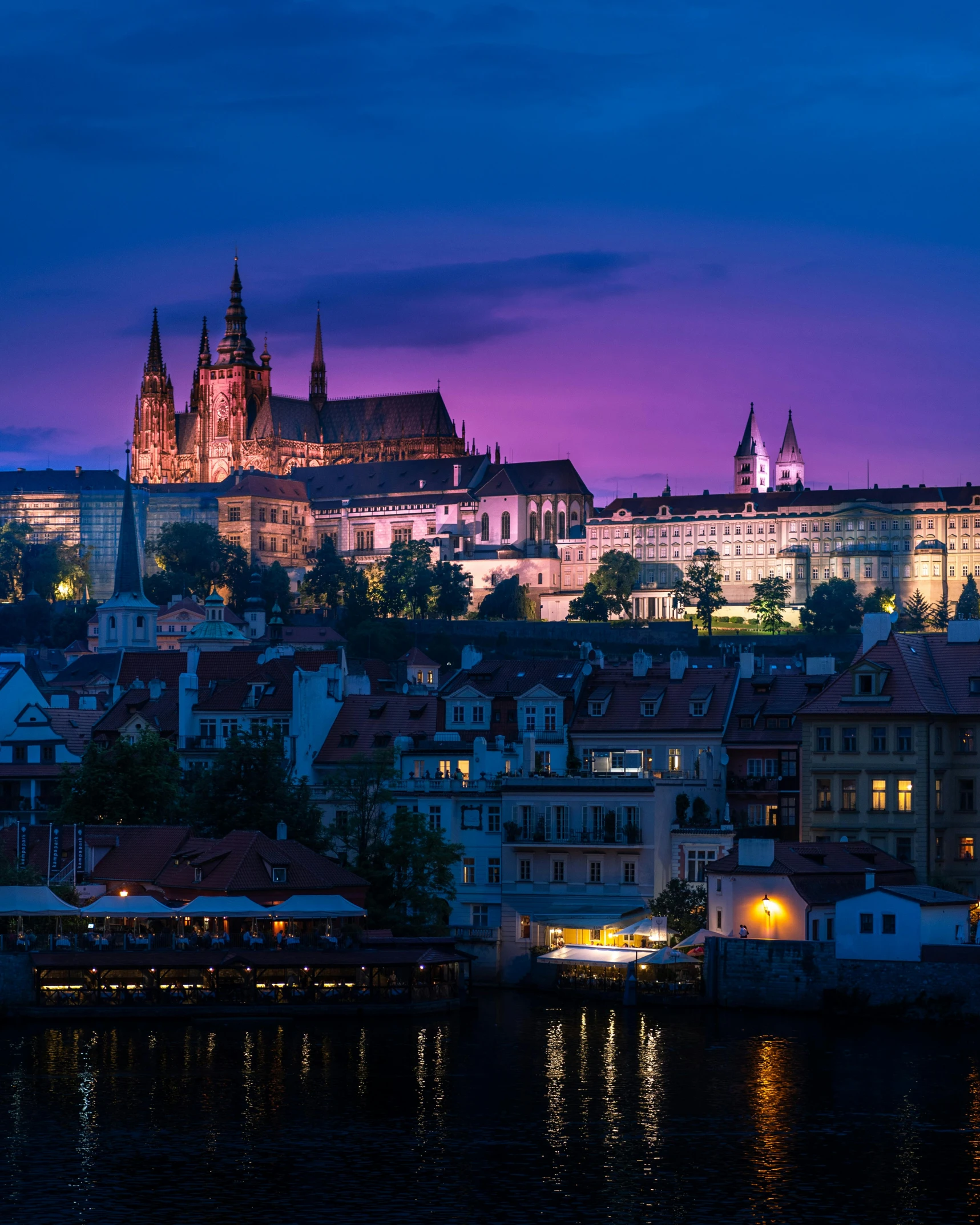 the city of prague is lit up at night, pexels contest winner, art nouveau, bisexual lighting, square, castle background, 🚿🗝📝