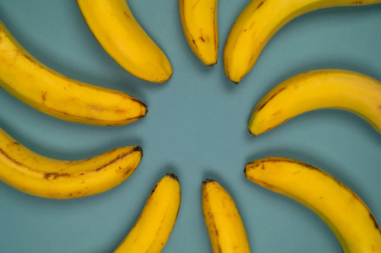 a group of bananas sitting on top of a blue surface