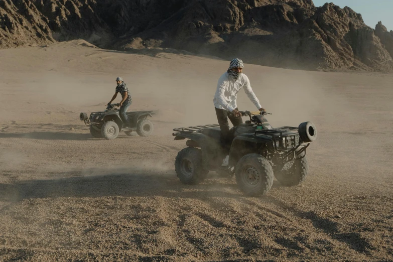 two people riding four wheelers in the desert, by Daniel Seghers, pexels contest winner, hurufiyya, highly detailed vfx, red sea, thumbnail, grey