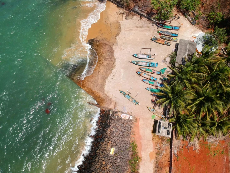 a group of boats sitting on top of a sandy beach, pexels contest winner, hurufiyya, sri lanka, airplane view, 🦩🪐🐞👩🏻🦳, small canoes