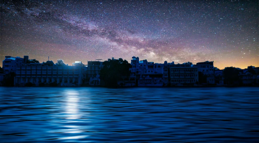 a large body of water next to a city under a night sky, a matte painting, by Julia Pishtar, pexels contest winner, india, stars and paisley filled sky, panoramic photography, the photo was taken from a boat