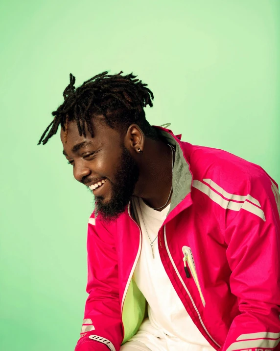 a man with dreadlocks sitting on a chair, inspired by Ras Akyem, trending on pexels, wearing a track suit, portrait happy colors, jaylen brown, wearing a turtleneck and jacket