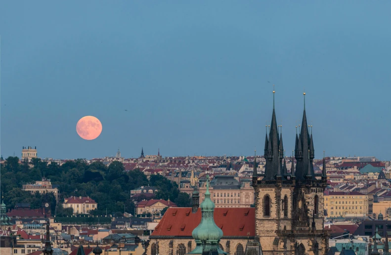 a view of a city with a full moon in the sky, by karolis strautniekas, pexels contest winner, art nouveau, square, prague, total lunar eclipse, full frame image
