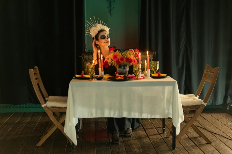 a woman sitting at a table with candles, inspired by Pietro Longhi, pexels contest winner, vanitas, dia de muertos dress and make up, chef table, dave mckean and stina persson, profile image