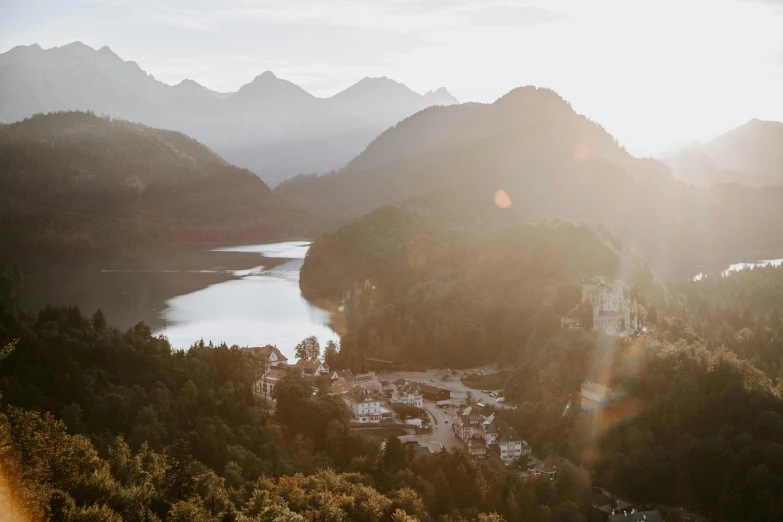 a bird's eye view of a lake and mountains, happening, sun flares, germany, conde nast traveler photo, no watermarks