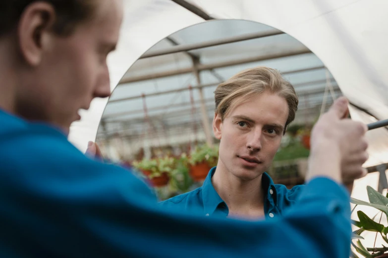 a man taking a picture of himself in a mirror, by Julian Allen, unsplash, renaissance, outside in a farm, long swept back blond hair, portrait of young man, gardening