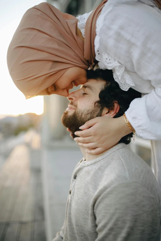 a man kissing a woman with a turban on his head, trending on pexels, white hijab, square, caucasian, tight around neck