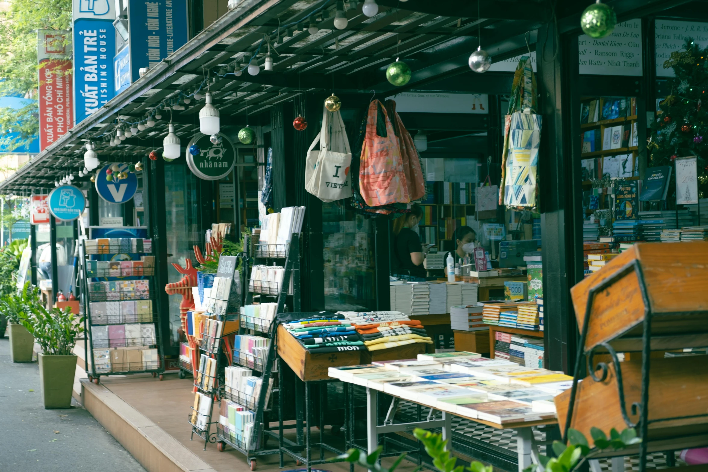 a book store sitting on the side of a street, unsplash, mingei, crafts and souvenirs, 90's photo