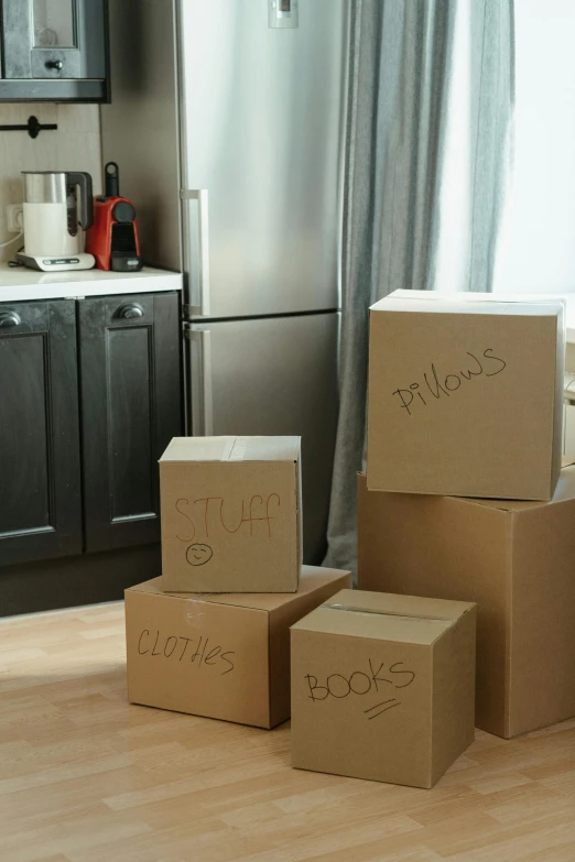 a bunch of boxes sitting on top of a wooden floor, fridge, profile image, apartment, label