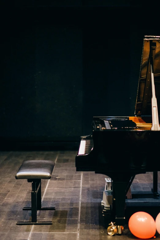 a black piano sitting on top of a wooden floor, by Niko Henrichon, trending on unsplash, modernism, footage of a theater stage, 15081959 21121991 01012000 4k, feat of artistic achievement, university