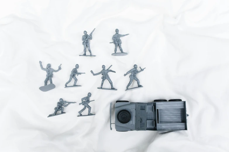 a group of toy soldiers sitting on top of a bed, grey, kombi, product shot, brilliant