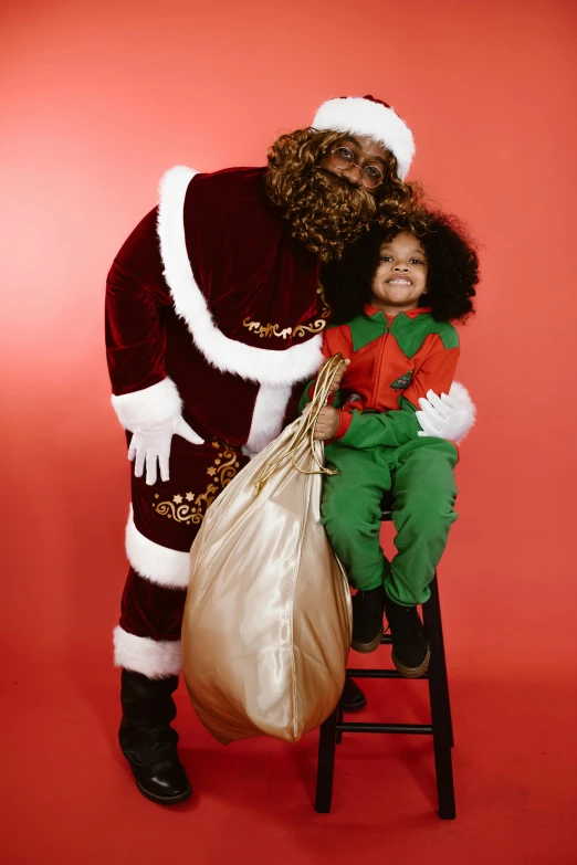 a little girl sitting on a stool next to a santa clause, an album cover, pexels, brown skin man egyptian prince, full frame image, black curly beard, gif