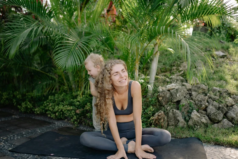 a woman and a child sitting on a yoga mat, a portrait, unsplash, in a jungle, avatar image, focus on full - body, toddler