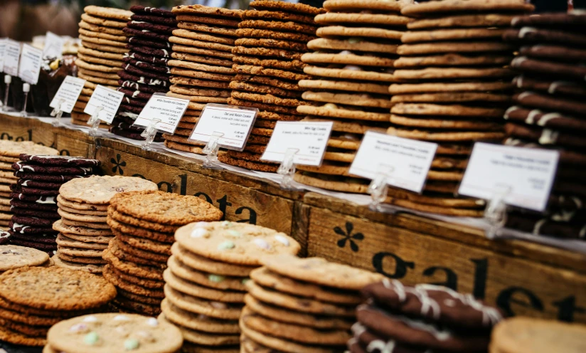 a display case filled with lots of cookies, by Lee Loughridge, pexels, arts and crafts movement, market stalls, stacked image, instagram post