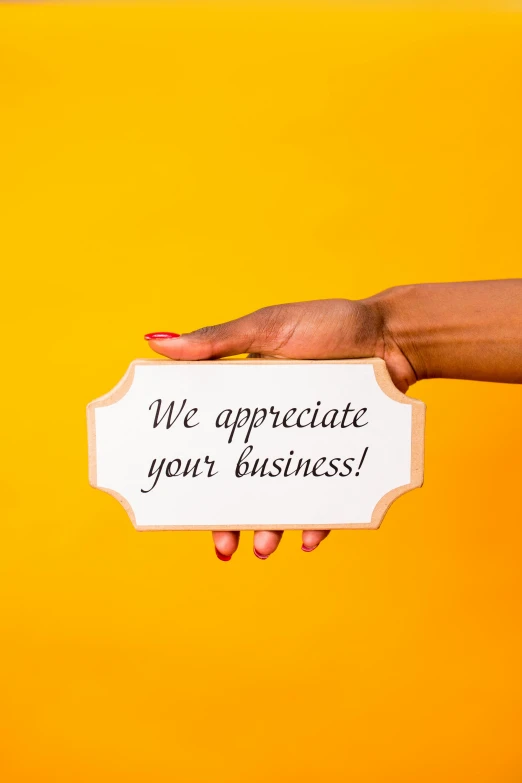 a person holding a sign that says we appreciate your business, gradient yellow, curated collections, thumbnail, diecut