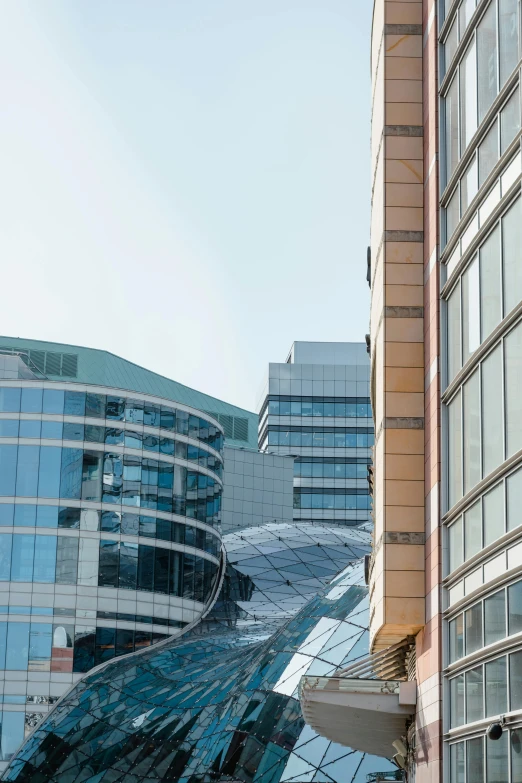 a couple of buildings that are next to each other, in a cybercity, southdale center, glass ceilings, curvy build