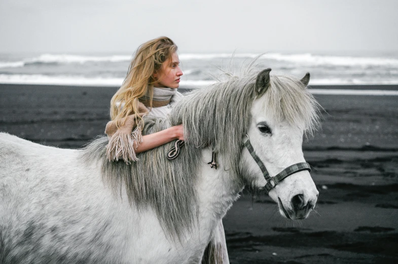 a woman riding on the back of a white horse, by Daniel Lieske, pexels contest winner, black sand, silver hair (ponytail), sadie sink, 4yr old