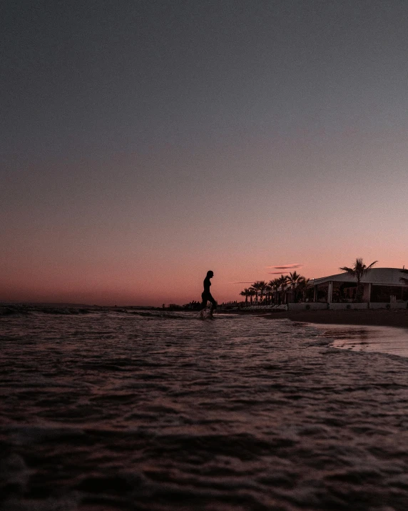 a man standing on top of a beach next to the ocean, in the evening, profile image, marbella, floating in the ocean