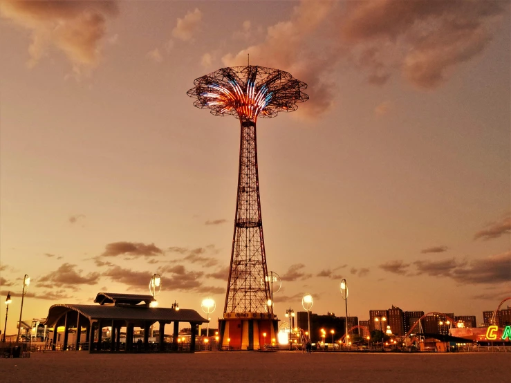 a tall tower sitting on top of a sandy beach, by Jacob Burck, unsplash contest winner, art nouveau, multiple lights, brooklyn, jc park, that is 1300 feet tall