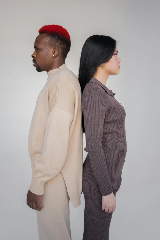 a man and a woman standing next to each other, brown sweater, mix of ethnicities and genders, facing away from camera, modelling