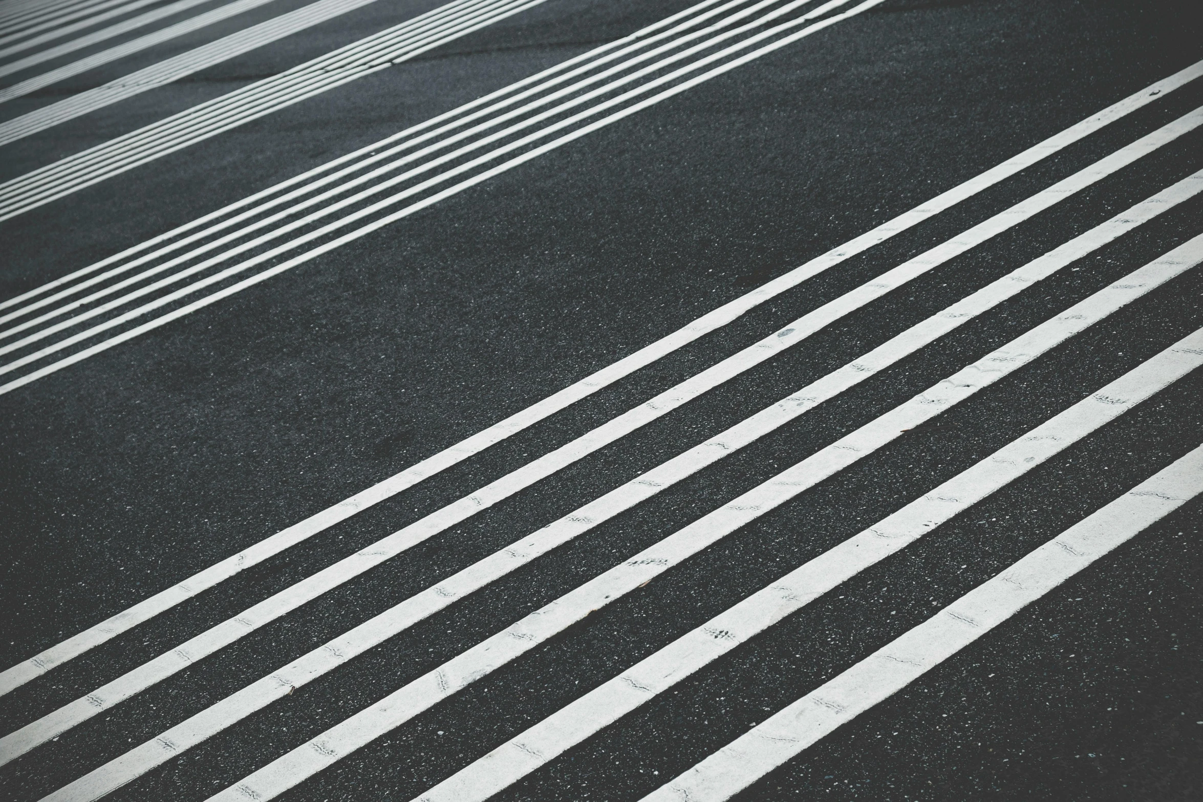 a red fire hydrant sitting on the side of a road, a black and white photo, inspired by Alexander Rodchenko, unsplash, op art, crossing the line, charcoal and silver color scheme, steps leading down, white stripes all over its body