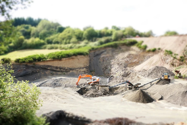 a couple of trucks that are sitting in the dirt, a tilt shift photo, by Daarken, unsplash, figuration libre, muddy embankment, sinkhole, worksafe. instagram photo, mark miner