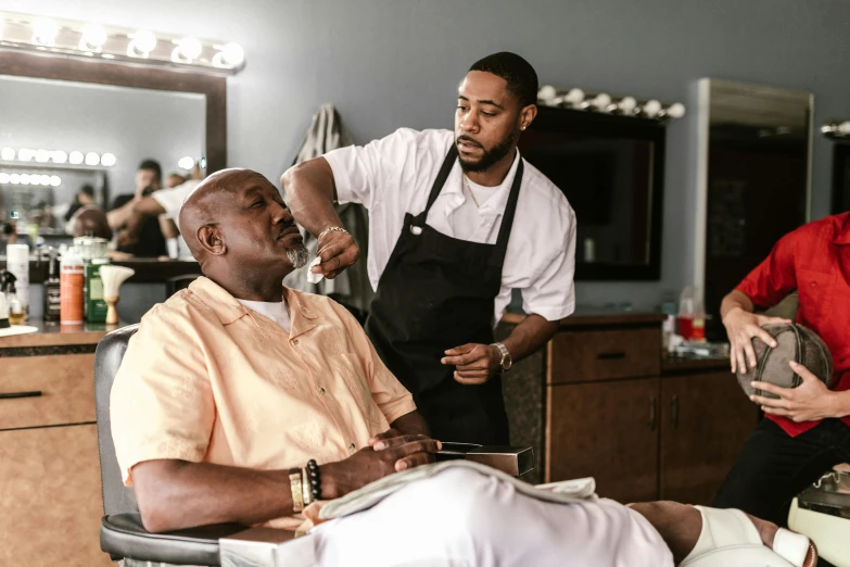 a man getting a haircut at a barber shop, pexels contest winner, huell babineaux, tv show still, a salt&pepper goatee, profile pic