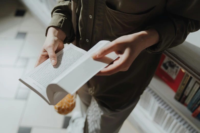 a person holding a book and a donut, pexels contest winner, private press, paper airplane, ultrarealistic, avatar image, white paper