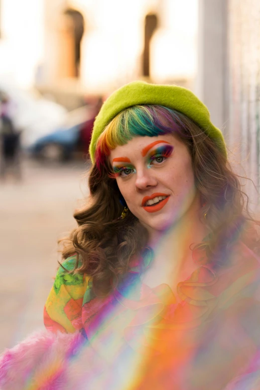 a woman with rainbow paint on her face, an album cover, by Emily Mason, renaissance, on sidewalk, she is wearing a hat, vibrantly lush, heath clifford