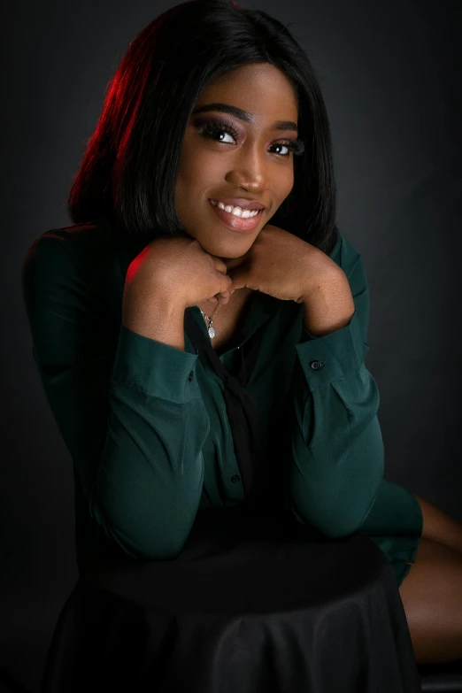 a woman sitting on top of a black table, a portrait, by Chinwe Chukwuogo-Roy, pexels contest winner, smiling young woman, closeup headshot, professional studio photo, laying down