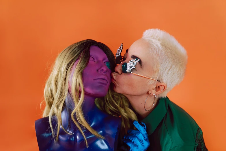 a couple of people that are kissing each other, an album cover, by Olivia Peguero, posing as a jojo character, an alien, julia hetta, shot in the photo studio