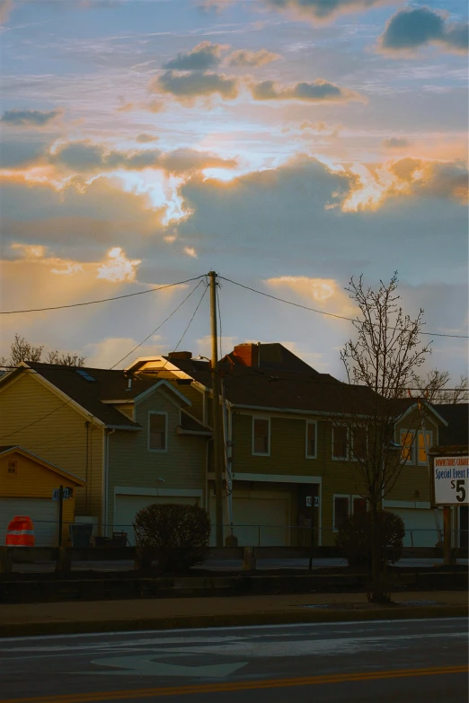 a couple of houses sitting on the side of a road, inspired by Gregory Crewdson, unsplash, photorealism, golden hour 8k, yellow clouds, soft light - n 9, city morning