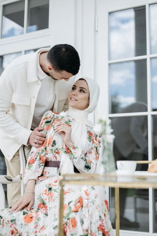 a man standing next to a woman in a dress, inspired by Maryam Hashemi, trending on pexels, hurufiyya, white hijab, romantic themed, patterned, on a white table