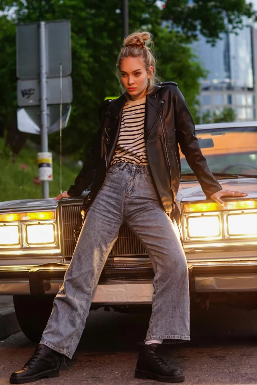 a woman sitting on the hood of a car, inspired by Bruce Gilden, trending on pexels, photorealism, pete davidson, large pants, very aesthetic leather jacket, stripes