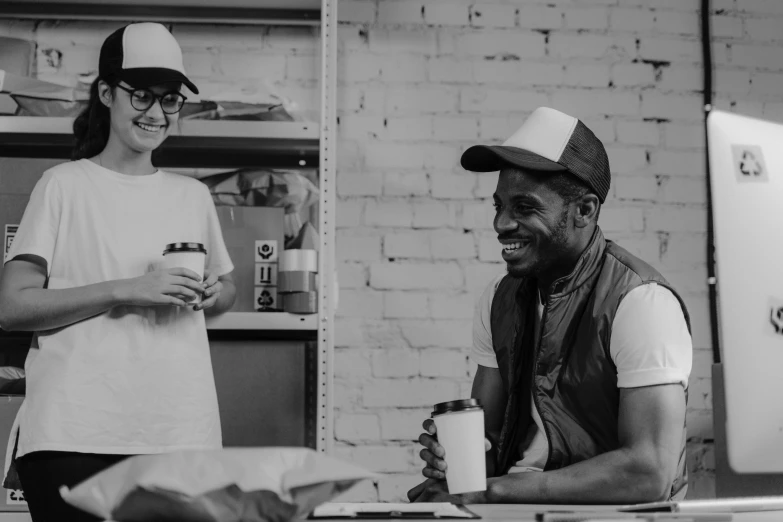 a black and white photo of a man and a woman, pexels contest winner, process art, starbucks aprons and visors, black man, friendly smile, small manufacture