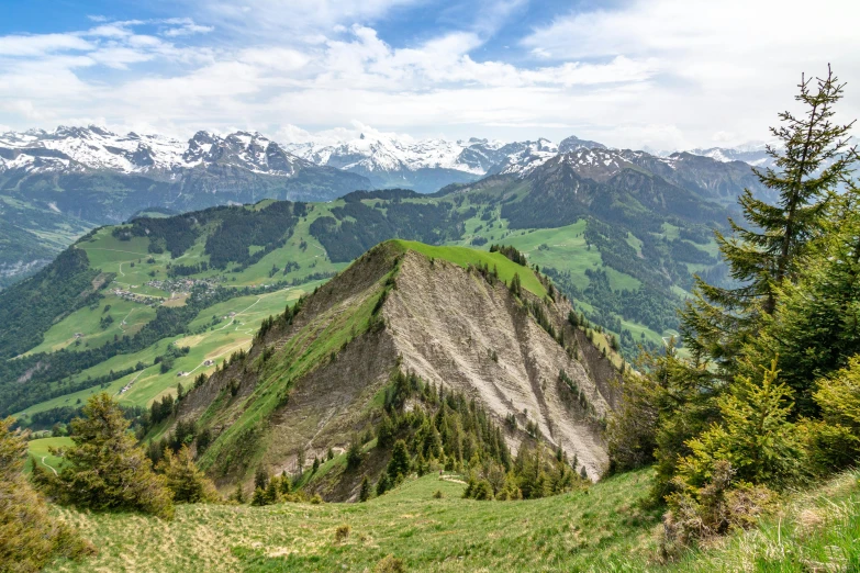 a view of the mountains from the top of a hill, by Johannes Voss, pexels contest winner, les nabis, switzerland, geiger, slide show, pyramid surrounded with greenery