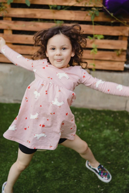 a little girl jumping in the air with a frisbee, inspired by Annabel Kidston, happening, tunic, hearts, full product shot, “pig