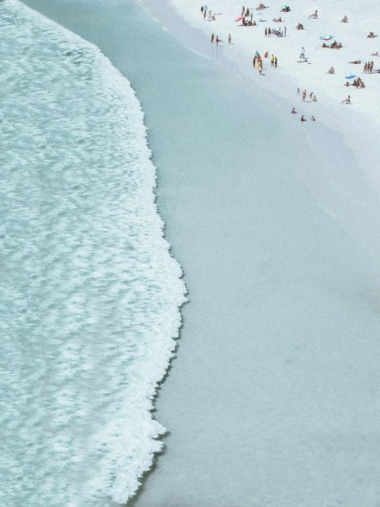 a group of people standing on top of a beach next to the ocean, inspired by Andreas Gursky, unsplash contest winner, minimalism, the emerald coast, sea foam, hyperdetailed photograph, white and blue