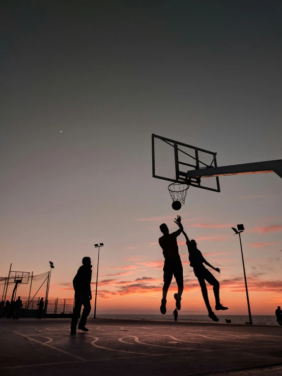 a group of people playing a game of basketball, by Matija Jama, unsplash contest winner, realism, dusk sky, manly, taken in the late 2000s, instagram story