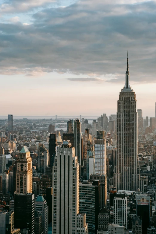 a view of a city from the top of a building, unsplash contest winner, hudson river school, tall metal towers, empire state building, late afternoon, 8k resolution”