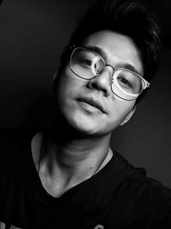 a black and white photo of a man wearing glasses, by Robbie Trevino, darren quach, he is about 20 years old | short, lgbtq, discord profile picture