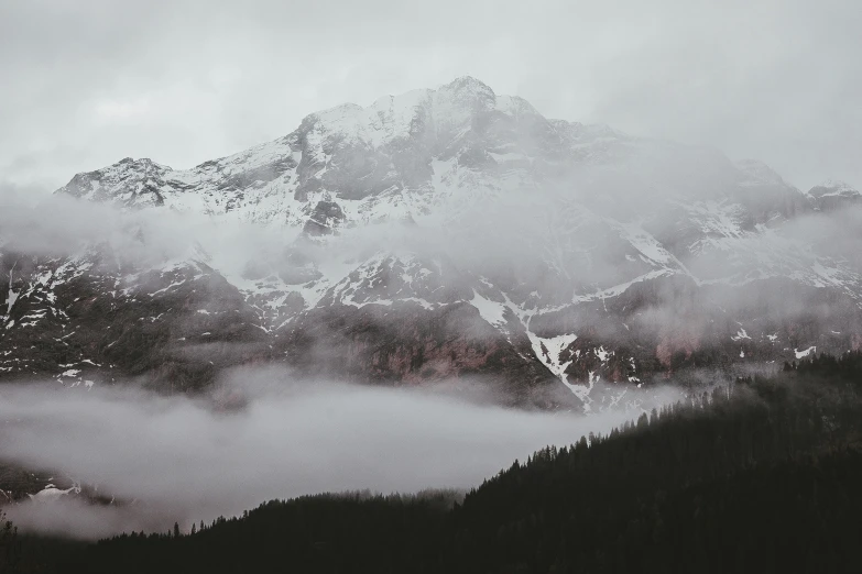 a mountain covered in snow on a cloudy day, pexels contest winner, romanticism, trending on vsco, mist floats in the air, multiple stories, ansel ]