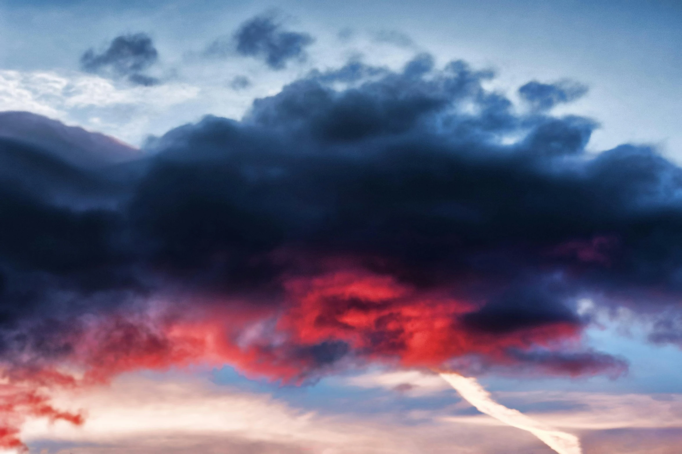 a couple of jetliners flying through a cloudy sky, an album cover, unsplash, romanticism, red cumulonimbus clouds, sunset panorama, dark blue and red, tumultuous