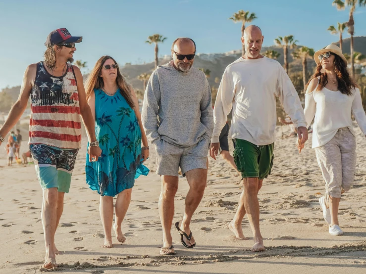 a group of people walking on a beach, bald head, backstreet boys, patterned clothing, holiday vibe