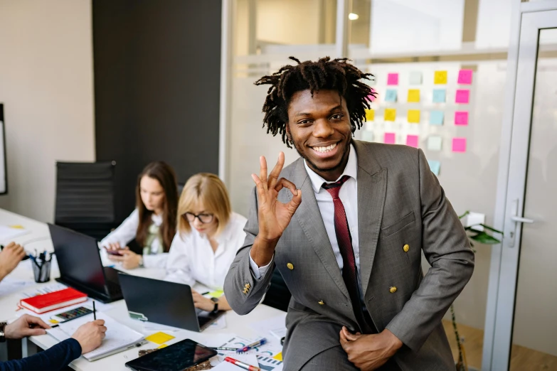 a man in a suit standing in front of a group of people, afro tech, sat in an office, satisfied pose, uwu