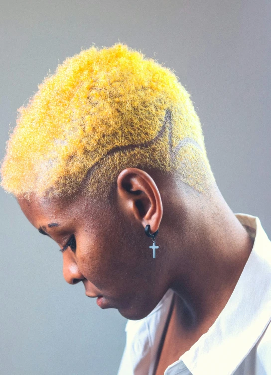 a close up of a person with a cell phone, an album cover, by artist, afrofuturism, bleached blonde short hair, profile image, mono-yellow, tattoos and piercings