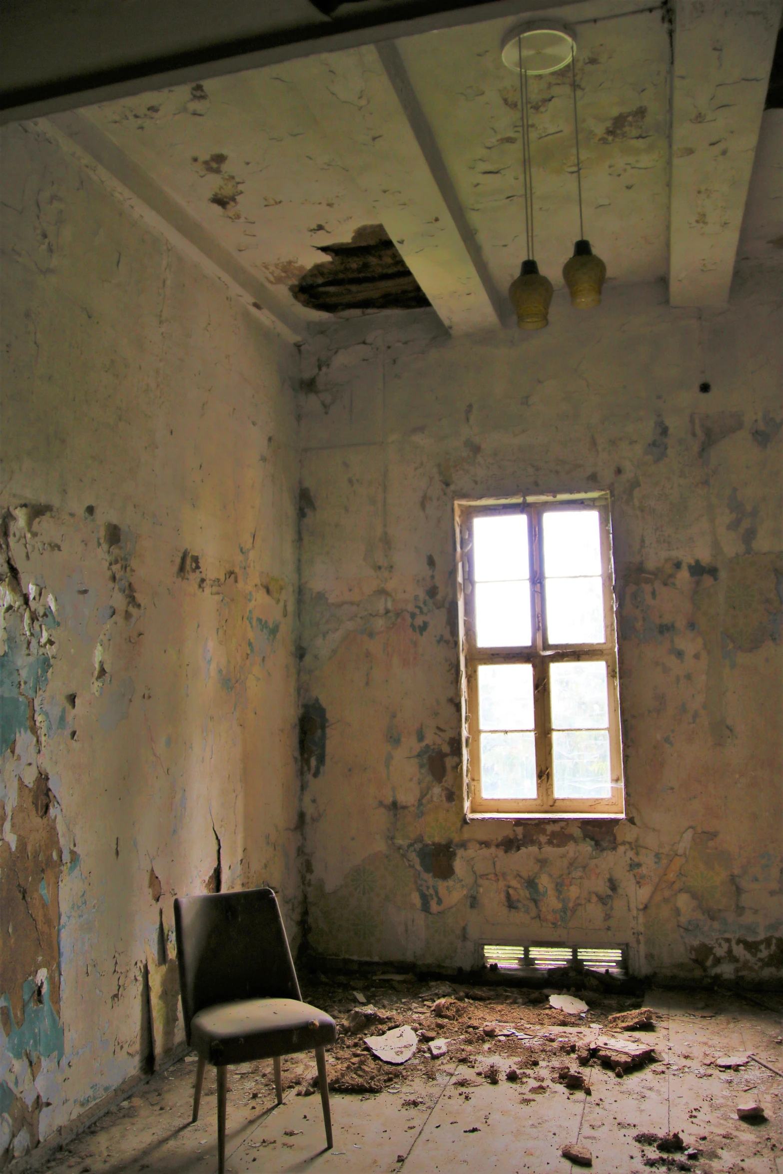 an empty room with a chair and a window, by Rudolf Schlichter, flickr, broken leaking cell wall, inside a castle, low ceiling, color photos