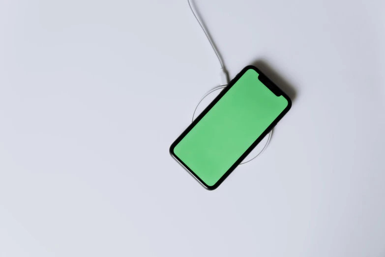 a close up of a cell phone with a green screen, trending on pexels, minimalism, floating power cables, white minimalistic background, square, apple design